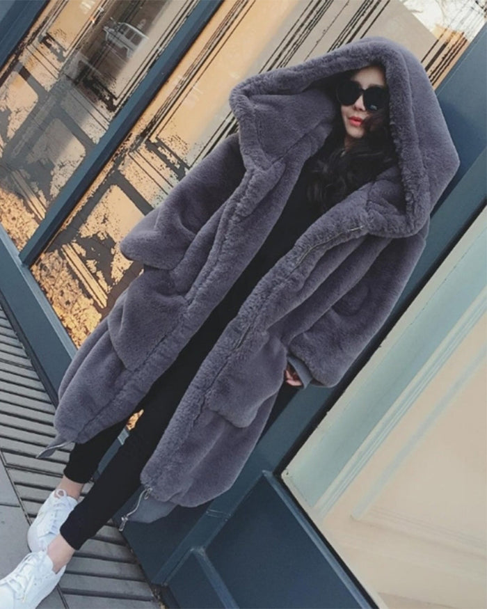 fashion model standing outside wearing her oslo grey oversized faux fur coat